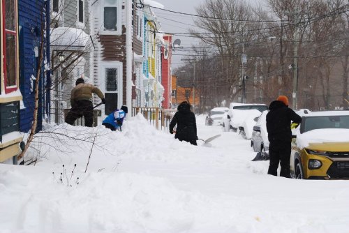 Residents of St. John's, N.L., are shown digging out from under about 40 centimetres of snow on Monday Feb. 10, 2025, after an intense winter storm swept across the eastern part of Newfoundland. THE CANADIAN PRESS/Sarah Smellie