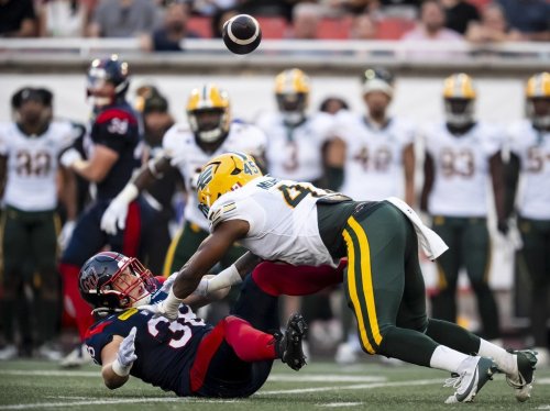 Edmonton Elks' Nyles Morgan (45) hits Montreal Alouettes' Jacob Mason (38) during first half CFL action against the Montreal Alouettes in Montreal on Friday, Aug. 8, 2025. THE CANADIAN PRESS/Christopher Katsarov