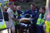 Emergency workers transport a person on a stretcher after a reported shooting at Bondi Beach, in Sydney, Sunday, Dec. 14, 2025. (AP Photo/Mark Baker)