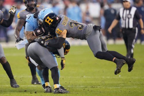 Hamilton Tiger-Cats defensive back Stavros Katsantonis (30) and defensive back Richard Leonard (23) tackle Toronto Argonauts running back Daniel Adeboboye (21) during first half CFL football action in Toronto on Friday, Sept. 20, 2024. THE CANADIAN PRESS/Nathan Denette