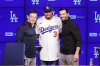 Edwin Díaz, middle, poses for photos next to General Manager Brandon Gomes, right, and President of Baseball Operations Andrew Friedman during his introduction as a new member of the Los Angeles Dodgers baseball team Friday, Dec. 12, 2025, in Los Angeles. (AP Photo/Ethan Swope)