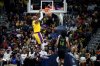 Los Angeles Lakers forward LeBron James (23) dunks next to New Orleans Pelicans guard Micah Peavy (14) during the first half of an NBA basketball game in New Orleans, Tuesday, Jan. 6, 2026. (AP Photo/Matthew Hinton)