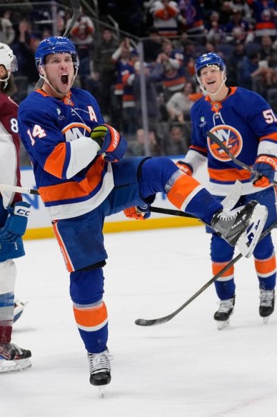 New York Islanders' Bo Horvat (14) reacts after scoring during the second period of an NHL hockey game against the Colorado Avalanche, Thursday, Dec. 4, 2025, in Elmont, N.Y. (AP Photo/Seth Wenig)