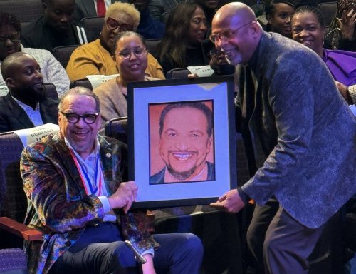 This photo provided by Capital Entertainment, Grammy Award Nominated Gospel Singer Richard Smallwood is handed a portrait of himself during his 75th Birthday Celebration. (Capital Entertainment via AP)