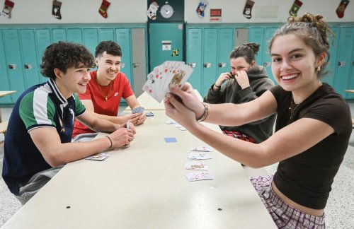 High school students Raphael Lortie (left), Hugo Blanvillain, Marianne Laflamme and Rachelle Paquette, play cards at Mgr-Parent in Longueuil, Que., on Thursday Dec. 18, 2025. The Canadian Press/Graham Hughes