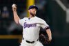 FILE - Texas Rangers starting pitcher Merrill Kelly throws to the Arizona Diamondbacks in the first inning of a baseball game, Aug. 13, 2025, in Arlington, Texas. (AP Photo/Tony Gutierrez, File)