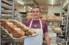 Brendan Hillson, the owner of McBride's Bakery in Medicine Hat, Alta., poses with a tray of doughnuts, in this undated handout photo. THE CANADIAN PRESS/Handout - Brendan Hillson (Mandatory Credit)