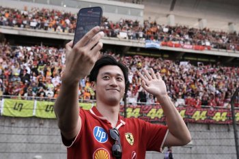 FILE - Ferrari driver Zhou Guanyu takes a selfie before the Chinese Formula One Grand Prix race at the Shanghai International Circuit, Shanghai, China, Sunday, March 23, 2025. (AP Photo/Andy Wong, file)