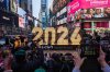 People take photographs as the 7-foot tall 2026 numerals are displayed at an illumination ceremony in Times Square, Thursday, Dec. 18, 2025, in New York. (AP Photo/Adam Gray)