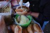 A vendor prepares a bolillo, a traditional Mexican bread, for consumption at a street stand in Mexico City, Thursday, Dec. 18, 2025. (AP Photo/Marco Ugarte)