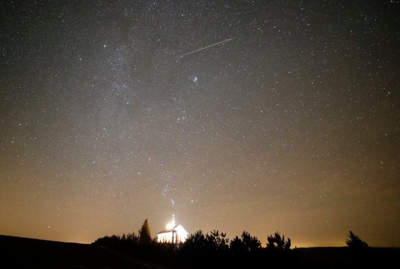 A meteor streaks over an Orthodox church during the annual Geminid meteor shower near the village of Zagorie, Belarus, in 2017. (Sergei Grits / The Associated Press files)
