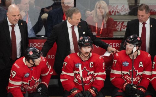 Canadian head coach Jon Cooper (back centre) behind the bench with Nathan MacKinnon (29), Sidney Crosby (87) and Connor McDavid (97) during the 4 Nations Face-Off in Montreal on Saturday, Feb. 15, 2025. THE CANADIAN PRESS/Christinne Muschi