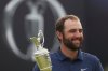 FILE - Scottie Scheffler of the United States holds the Claret Jug trophy as he poses for photographers after winning the British Open golf championship at the Royal Portrush Golf Club, Northern Ireland, July 20, 2025. (AP Photo/Peter Morrison, File)