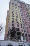Rescue workers clear the rubble of a residential building which was heavily damaged after a Russian strike on Kyiv, Ukraine, on Saturday, Dec. 27, 2025. (AP Photo/Evgeniy Maloletka)