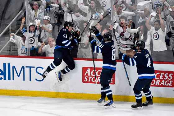 Winnipeg Jets' Cole Perfetti (91) celebrates his goal to tie the game against the St. Louis Blues with Kyle Connor (81) and Neal Pionk (4) during third period NHL round one, game seven Stanley Cup playoff action in Winnipeg, Sunday May 4, 2025. (Fred Greenslade / The Canadian Press files)