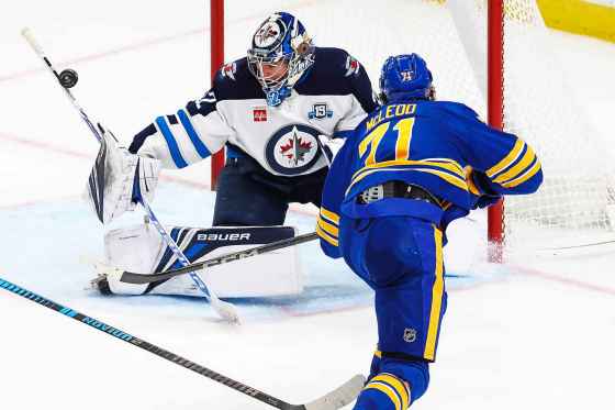 Winnipeg Jets goaltender Thomas Milic, left, stops Buffalo Sabres center Ryan McLeod (71) during the third period of an NHL hockey game on Dec. 1, 2025, in Buffalo, N.Y. (Jeffrey T. Barnes / The Associated Press files)