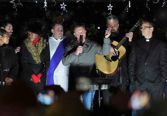 Tommy Robinson (centre) speaks during a Christmas carol service in Whitehall, London, Saturday Dec. 13, 2025, (Jonathan Brady / The Associated Press)