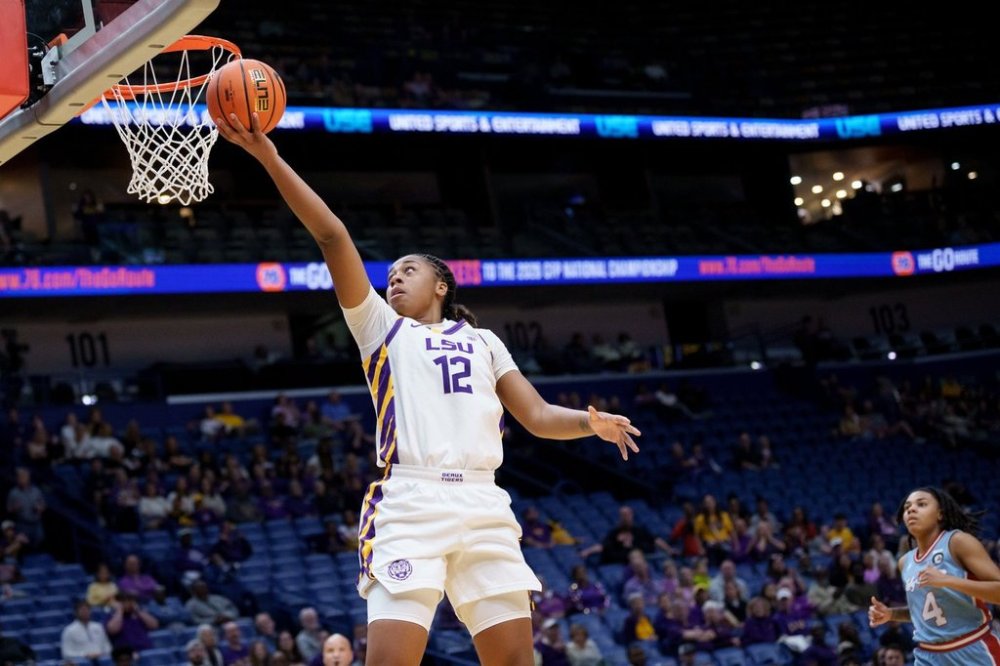 LSU guard Mikaylah Williams (12) makes a basket ahead of Louisiana Tech guard Joy Madison-Key (4) during the first half of an NCAA college basketball game Saturday, Dec. 13, 2025, in New Orleans. (AP Photo/Matthew Hinton)