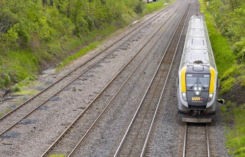 A VIA Rail train is seen on tracks in Dorval, Que., as it heads out of Montreal on Friday, May 23, 2025. THE CANADIAN PRESS/Christinne Muschi