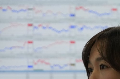 A dealer watches computer monitors at a dealing room of Hana Bank in Seoul, South Korea, Thursday, Jan. 8, 2026. (AP Photo/Lee Jin-man)