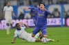 Monaco's Takumi Minamino, right, reacts as he challenges with Marseille's Geoffrey Kondogbia during the French League One soccer match between Marseille and Monaco in Marseille, France, Sunday, Dec. 14, 2025. (AP Photo/Philippe Magoni)