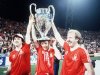 FILE - Nottingham Forest's John Robertson, left, Ian Bowyer, center, and Kenny Burns, right, carry the European Cup in triumph after their 1-0 win against Malmo FF in Munich, Germany, May 30, 1979. (AP Photo, File)