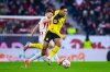 CORRECTS TEAM TO BORUSSIA DORTMUND - Freiburg's Lucas Hoeler, left, and Dortmund's Jobe Bellingham, right, challenge for the ball during the German Bundesliga soccer match between SC Freiburg and Borussia Dortmund in Freiburg, Germany, Sunday, Dec. 14, 2025. (Tom Weller/dpa via AP)