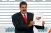 FILE - Venezuela's President Nicolas Maduro holds up the National Electoral Council certificate declaring him the winner of the presidential election, during a ceremony at CNE headquarters in Caracas, Venezuela, May 22, 2018. (AP Photo/Ariana Cubillos, File)