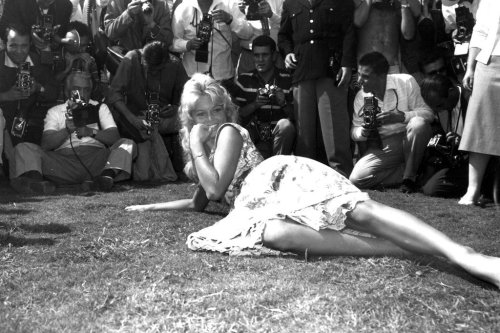 FILE - French actress Brigitte Bardot poses for photographers on a lawn in the garden of the Excelsior Hotel on the Lido of Venice, Italy, Sept. 2, 1958. (AP Photo/Walter Attenni, File)