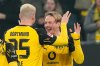 Dortmund's Julian Brandt, right, celebrates with Dortmund's Niklas Suele, left, after he scored the opening goal during the German Bundesliga soccer match between Borussia Dortmund and Borussia Moenchengladbach in Dortmund, Germany, Friday, Dec. 19, 2025. (AP Photo/Martin Meissner)