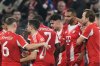 Bayern Munich players celebrate after Bayern's Jonathan Tah, second right, scored his side's third goal during the Champions League opening phase soccer match between FC Bayern Munich and Sporting CP in Munich, Germany, Tuesday, Dec. 9, 2025. (AP Photo/Matthias Schrader)