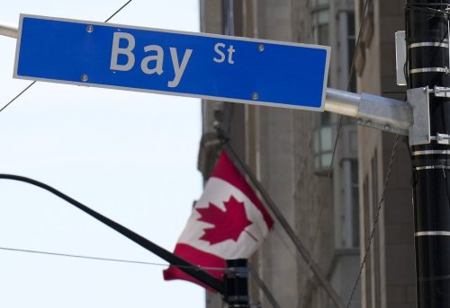 A Canadian flag flies in the Bay Street financial district in Toronto on Friday, August 5, 2022. THE CANADIAN PRESS/Nathan Denette