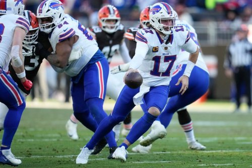 Buffalo Bills quarterback Josh Allen (17) hands off against the Buffalo Bills during the second half of an NFL football game in Cleveland, Sunday, Dec. 21, 2025. (AP Photo/Sue Ogrocki)