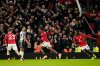 Manchester United's Patrick Dorgu, center, celebrates after scoring the opening goal during the English Premier League soccer match between Manchester United and Newcastle in Manchester, England, Friday, Dec. 26, 2025. (AP Photo/Dave Thompson)