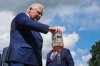 Ontario Premier Doug Ford empties a Crown Royal bottle of whisky at a press conference in Kitchener, Ont., on Tuesday, Sept. 2, 2025. Ford criticized the popular whisky's parent company, Diageo, for their plan to close one of their Ontario bottling plants in the coming months. THE CANADIAN PRESS/Sammy Kogan