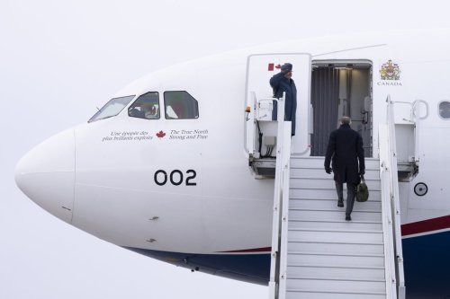 Prime Minister Mark Carney boards a government plane in Ottawa on Monday, Jan. 5, 2026. THE CANADIAN PRESS/Christinne Muschi