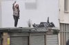 A person takes a selfie of a piece of graffiti artwork depicting two children, in London, Monday, Dec. 22, 2025 as elusive street artist Banksy appeared to confirm Monday that a new mural in London, depicting two children lying down and pointing up at the sky, is his latest work. (Stefan Rousseau/PA via AP)