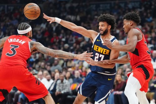 Denver Nuggets guard Jamal Murray (27) makes pass as Toronto Raptors forward Brandon Ingram (3) and guard Ochai Agbaji (30) defend during first half NBA action in Toronto on Wednesday December 31, 2025.  THE CANADIAN PRESS/Frank Gunn