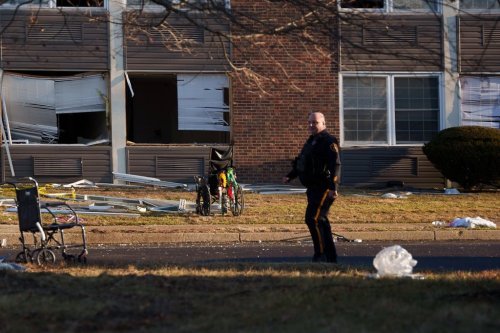 A responder navigates around Bristol Health & Rehab Center and surrounding rubble after a gas explosion the day prior on Wednesday, Dec. 24, 2025, in Bristol, Pa. (AP Photo/Mingson Lau)