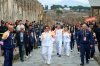 Actor Jackie Chan holds the olympic torch passing through the Archaeological Park in Pompeii, Italy, Monday, Dec. 22, 2025. (Alessandro Garofalo/LaPresse via AP)