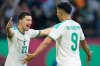 Algeria's Ibrahim Maza, left, celebrates with Algeria's Baghdad Bounedjah after scoring his side's third goal during the Africa Cup of Nations group E soccer match between Algeria and Sudan in Rabat, Morocco, Wednesday, Dec. 24, 2025. (AP Photo/Mosa'ab Elshamy)