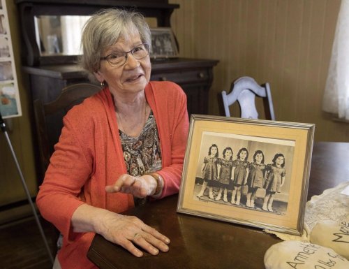 Annette Dionne, one of the Dionne quintuplets, visits the original cabin she was born in, which was relocated to downtown North Bay, Ont., next to the North Bay Museum, Sunday, Aug. 5, 2018. THE CANADIAN PRESS/Fred Thornhill