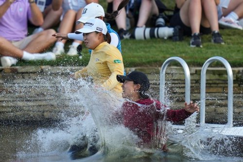 FILE -Mao Saigo, of Japan, in yellow, jumps into the water after winning the Chevron Championship LPGA golf tournament April 27, 2025, in The Woodlands, Texas. (AP Photo/Eric Gay, File)