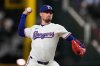 FILE - Texas Rangers relief pitcher Shawn Armstrong throws to the Arizona Diamondbacks in the eighth inning of a baseball game, Aug. 12, 2025, in Arlington, Texas. (AP Photo/Tony Gutierrez, File)