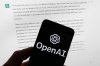 FILE - The OpenAI logo is displayed on a mobile phone in front of a computer screen with output from ChatGPT, March 21, 2023, in Boston. (AP Photo/Michael Dwyer, File)