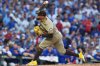 FILE - San Diego Padres' Robert Suarez throws the ball during the sixth inning of Game 3 of a National League wild card baseball game against the Chicago Cubs, Oct. 2, 2025, in Chicago. (AP Photo/Nam Huh, File)