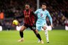 Bournemouth's Antoine Semenyo, left and Burnley's Josh Laurent vie for the ball during the English Premier League soccer match between Bournemouth and Burnley at the Vitality Stadium, in Bournemouth, England, Saturday, Dec. 20, 2025. (Andrew Matthews/PA via AP)