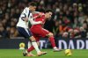 Tottenham's Brennan Johnson, left, duels for the ball with Liverpool's Curtis Jones during the English Premier League soccer match between Tottenham and Liverpool in London, Saturday, Dec. 20, 2025. (AP Photo/Ian Walton)
