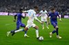 Marseille's Mason Greenwood, center, runs past to Monaco's Caio Henrique, right, during the French League One soccer match between Marseille and Monaco in Marseille, France, Sunday, Dec. 14, 2025. (AP Photo/Philippe Magoni)