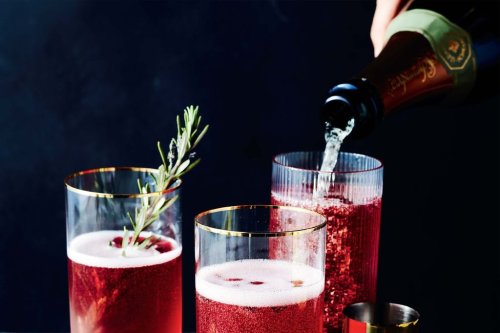 This image released by Voracious shows a recipe for a Champagne cocktail made with pomegranate juice, from the cookbook 